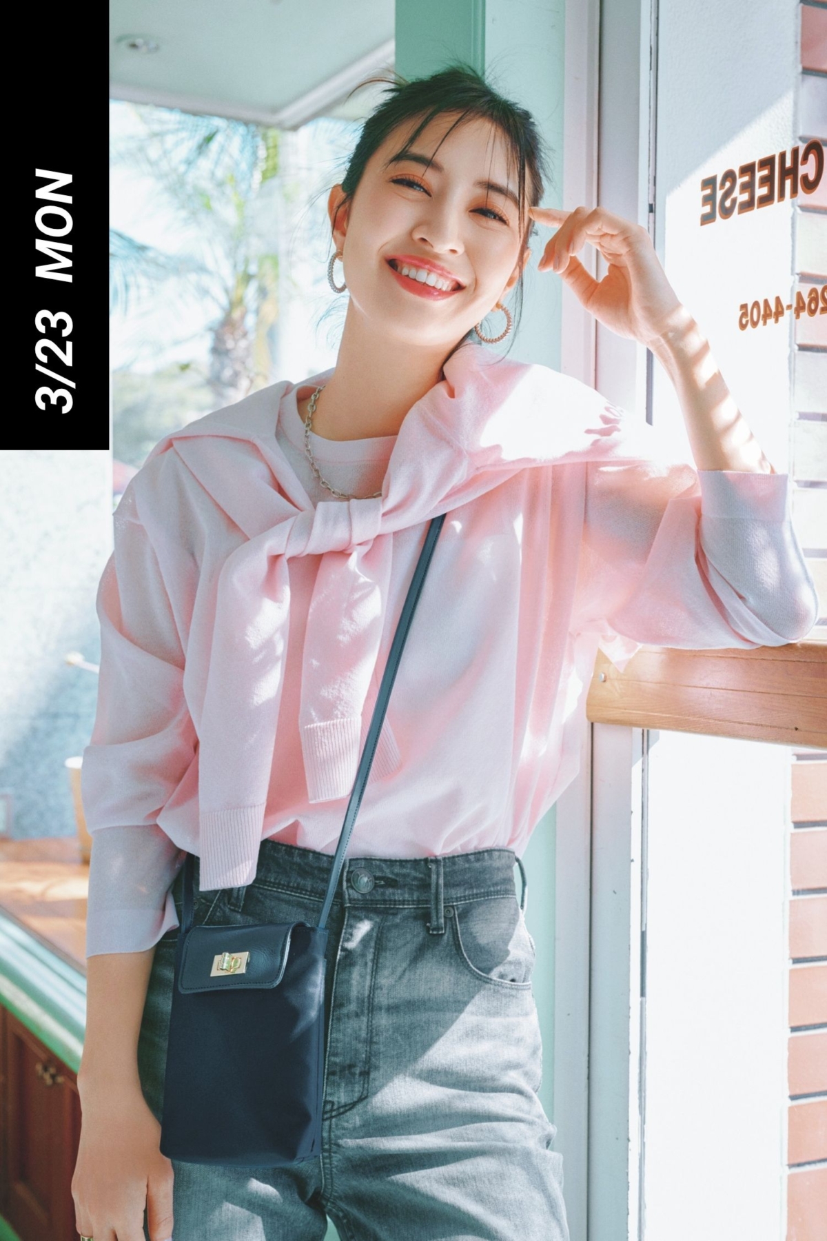 ピンクのツインニットとデニムにミニショルダーを斜めがけしたカジュアルコーデ