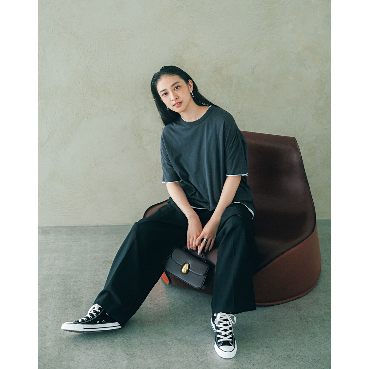 ゆるっとしたTシャツとスラックスの足元に黒のコンバースを合わせた武井咲さん